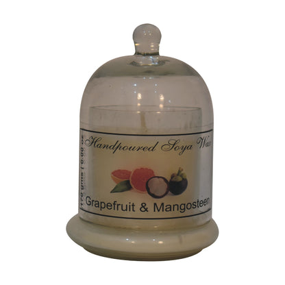 dome-shaped jar with a Grapefruit & mangosteen candle inside. set on a white background
