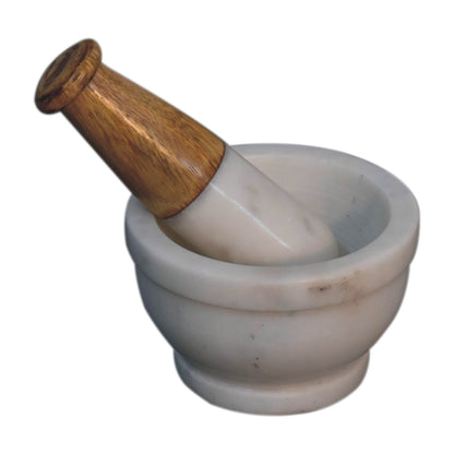 mortar and pestle, meticulously handcrafted from natural white marble and paired with a smooth wooden-accent handle